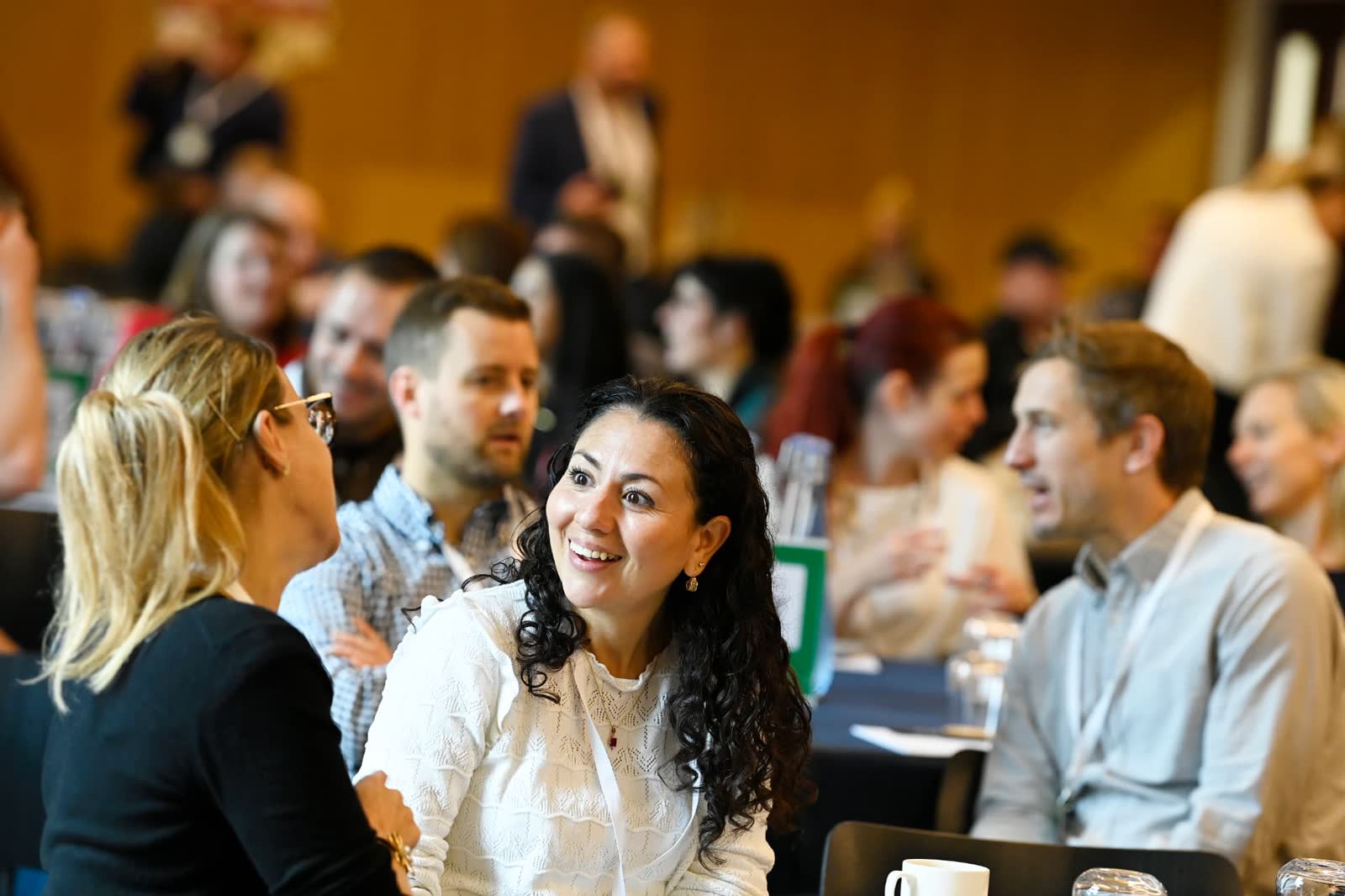 Attendees in conversation at a roundtable during the 2025 Forum